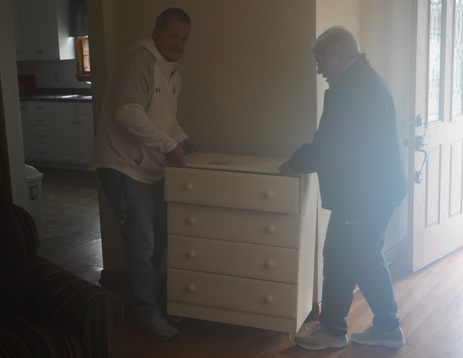 Sister Jean Dietrich of the School Sisters of Notre Dame, Helias Catholic High School’s office administrator and former principal, and Assistant Principal/Activities Director Dwayne Clingman deliver some furniture to a previously unoccupied home the school owns and is now allowing a resettled family from Afghanistan to live in rent-free.